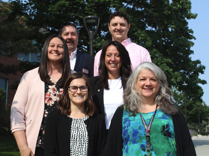 CPAR Staff of six people posing on steps