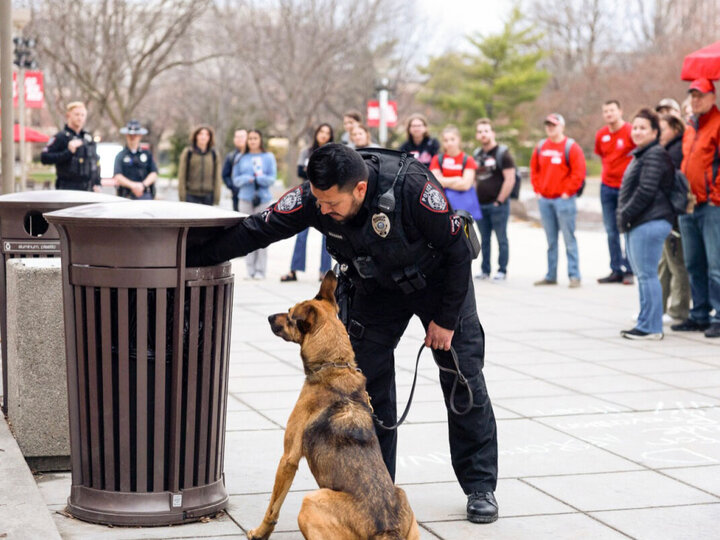 police officer on Lincoln campus with German Shepard looking for explosives